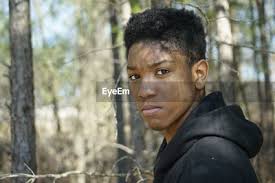 Portrait of teenage boy standing amidst