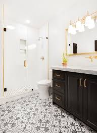 Black White And Gold Bathroom Decor Contemporary Gold And Black Bathroom Boasts A Black Single Washstand Accented With Brass Pulls And A Black White Gold Decor Gold Bathroom White And Gold Decor