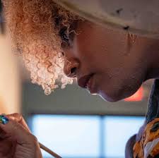 Legally blind artist Stephanie Gowdy creates painting at coffee shop