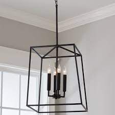 It showcases an open, geometric lantern shape, finished in a neutral black hue for a transitional look that blends in with a variety of color schemes. Harrington Lantern Chandelier Large Entryway Light Fixtures Lantern Light Fixture Modern Farmhouse Lighting