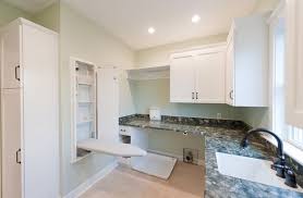 The ironing boards in our ironing board cabinets can be raised, lowered and turned so that you can easily iron from any side. Ironing Board Cabinet Extensions For Organized Laundry Rooms