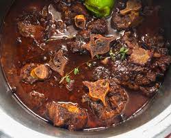 1 lb beef oxtail, 1 can butter beans, drained, 3 carrots, peeled and chopped, 3 tbsp cooking oil, 1 tsp oregano, 1 tsp parsley, 1 tbsp allspice, 1 dash paprika, 1 whole scotch bonnet pepper, marinade, 3 tbsp bottle oxtail seasoning (or oxtail seasoning sub if you don 't have; Juicy Jamaican Oxtail Recipe With Video Roxy Chow Down