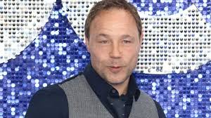 Who was Elton John's publisher Dick James and who plays him in Rocketman?