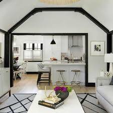 The grid creates squares using the beams that hang lower than the rest of the ceiling. Glossy Black Ceiling Beams Design Ideas