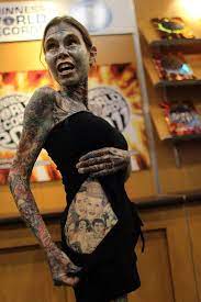 10 Of The Weirdest Guinness Records Ever Broken Weird Tattoos Cover Tattoo Guinness World