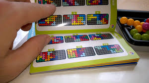 The top of the game board features a grid for 2d challenges and a separate grid for 3d pyramid challenges, while the bottom of the board features a completely different 2d challenge grid. Iq Puzzler Pro Unboxing Youtube