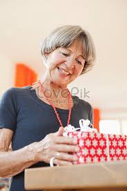 The cheerful wreath pictured above features fairly neutral colors, so she can keep it up past christmas. Old Lady Looking At Christmas Gifts Photo Image Picture Free Download 501519844 Lovepik Com