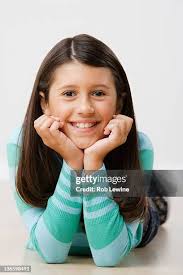 Portrait Of Girl Lying On Hardwood Floor At Home Romania High-Res Stock  Photo