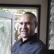 A shepherd watches his flock at the Hallstrom Trust Estate experimental  sheep farm at Nondugl in the Wahgi Valley. Photo by Verdun Gadsby,  Australasian Photo Review, March 1951.