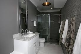 Masculine Bathroom Boasts Dark Gray Walls A Backdrop For White Vanity Topped With White Granite Countertop And L Masculine Bathroom Dark Grey Walls Grey Walls