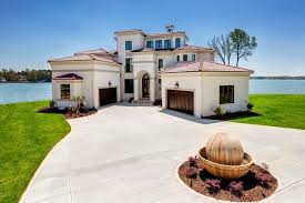 When choosing an exterior paint color, homeowners must take several things into consideration, such as the neighborhood, neighboring house colors, neighborhood association guidelines, where applicable, and most important, finding a color that will complement the red roof tiles without overwhelming them. Luxury Awaits In This Mediterranean Lake Side Home