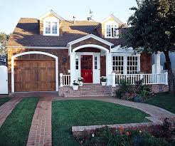 An Arched Portico Above A New Brick Stoop And An Adjoining Pergola Topped Porch Give This Cape Cod Home A Mor House Exterior House With Porch Exterior Makeover