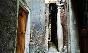 The small space, the ancient, brick walls on each side of it. Looking For The Narrowest Calle Inside Venice
