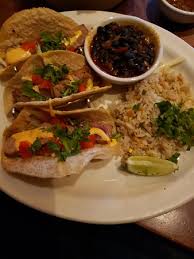 Two homemade corn tortillas, pork, spicy red chile sauce, onions, cilantro, cotija cheese with guacamole, pico de gallo, cilantro rice and spicy black beans. Fish Tacos Picture Of Uncle Julio S Gainesville Tripadvisor