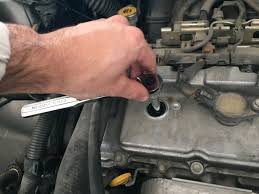 The plugs & coils on the front half are under the decorative cover. How To Change The Spark Plugs In Your 2004 2008 Toyota Sienna Axleaddict