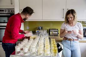 Home interiors 2 piece jar candle topper & plate flowers floral. Man And Woman Standing In Domestic Kitchen And Making Jar Candles Home Interior Creativity Stock Photo 266534968