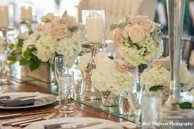 Centerpiece Collection Of Silver Candlesticks Mirror Table Runner Votive Candles And Wooden Boxes Of Peony Votive Candles Centerpieces Silver Candlesticks