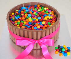 My Version Of The Kit Kat Cake A Triple Layer Chocolate Cake Surrounded By Kit Kats And Covered In M Ms And Smarti Kit Kat Cake Lolly Cake Cool Birthday Cakes