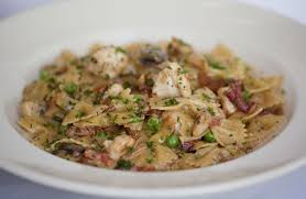 When butter is melted, swirl to coat the bottom of the roasting pan, and place the chicken drumsticks and thighs, potatoes, and unpeeled garlic cloves into the pan. Farfalle With Chicken And Roasted Garlic White Turkey Chili Recipe Cherry Tomato Recipes Pasta Dishes