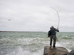 Take the tag end of line from the spool, and run it down through the guide that is closest to the reel. Long Distance Casting In The Surf On The Water