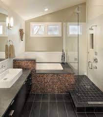 Cropped view of man holding container with pills near ceramic clean toilet bowl in modern restroom with grey tile. Bathroom Tile Ideas Tile Flooring Backsplash Shower Designs