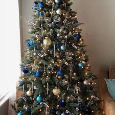 Blue and gold christmas decorations. Navy Cobalt Blue Silver Gold Christmas Tree With Striped Ribbon Blue Christmas Tree Decorations Christmas Tree Colour Scheme Christmas Tree Inspiration