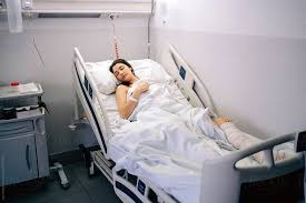 Female Patient Sleeping In A Hospital Stocksy United Hospital Patient Hospital Bed