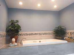 Whirlpool jets in this oval soaking tub add massage feature, while adjacent windows afford relaxing view outdoors. Bathroom Jacuzzi Tub Decor