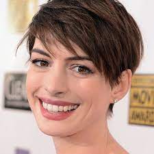 Portrait of a woman with brown stylish african american woman with short hair isolated on brown. The Best Short Haircuts For Brunettes