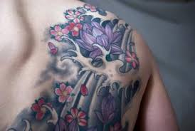 The wave of this tattoo accentuates the wearer's body, showcasing the beautiful flower in blue. Water Lily Tattoos Lovetoknow