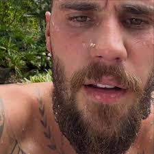 Bare-chested pop icon unrecognisable as he shows off new bushy beard