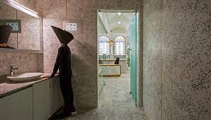 The walls are covered in a linen look vinyl wallpaper, the floor is adorned with mother of pearl terrazzo tiles and there is a huge custom shaving cabinet behind the simple custom framed mirror. Terrazzo Is Back Production Installation And Samples In Architecture Archdaily