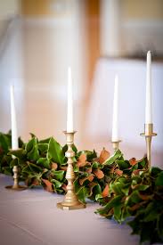Magnolia Garland Table Runner Matte Gold Candlesticks And White Taper Candles Magnolia Leaves Centerpiece Magnolia Garland Magnolia Wedding