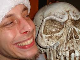 Jerad Miller, with blood visible in his right nostril, poses next to a  skull in this photo