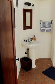 small spanish bathroom with pedestal