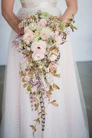 Utilize dusty miller to create a complete bouquet for a winter wedding or incorporate a few sprigs to add texture and a lighter color to a spring or summer design. 20 Stunning Cascading Bouquets Expert Tips From Florists Bridal Musings Cascading Wedding Bouquets Spring Wedding Bouquets Cascading Bridal Bouquets