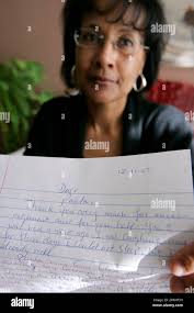 Paula Nourse poses with a letter from Angolan immigrant Isaac Manuel at her  home in Dallas, Monday, Dec. 17, 2007. Nourse and other friends say Manuel  should be offered the political asylum