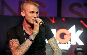 There is a huge ink on his back which includes his name's initials, i.e 'mgk' that stands for machine gun kelly. Machine Gun Kelly Reveals Hotel Diablo Release Date As He Gets Album Title Head Tattoo