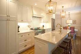 Mixing metals can help to create texture and layers in a modern and classic way. Transitional Custom Cabinets White Cabinets Brass Fixtures Antique Brass Pendent Lights S Transitional Decor Kitchen Remodel Transitional Decor Living Room