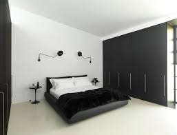A black padded headboard against a white wall, with a white fur bedspread and art deco fixtures, create a look of decadent luxury. 14 Black White Bedroom Ideas Create A Modern Minimalist Look Pictures Of Black And White Bedrooms