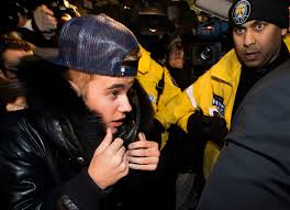 Justin Bieber turns himself in to Toronto police to face assault charge, then leaves
