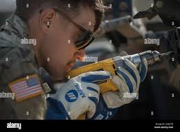 Idaho Army National Guard PV2 Zach Goodell works at trying to remove a bolt  jammed in the trailer equipment. Closing in