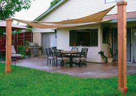 A Guide To Buying The Right Sun Shades Sun Shade Made In The Shade Custom Stamped Concrete Patio With Shade Sails Shade Sails Patio Patio Shade Backyard Shade