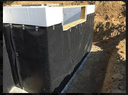 Laying down a layer of 6mm plastic to create a water barrier. Image Gallery Building America Solution Center