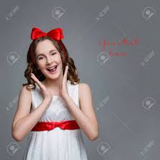 Flat silver crimped curling ribbon 3/16 x 500 yards. Beautiful Teenage Girl With Long Curly Hair And Red Ribbon Bow On Head Wearing White Dress Happy Expression Studio Portrait On Grey Background Copy Space Stock Photo Picture And Royalty Free Image