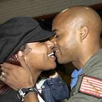 Unidentified U.S. Navy, ex-POW gets a hug from one of the many well wishers  who came to the flight line to say goodbye as he leaves for the United  States