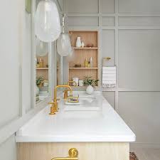 Formed of compressed and heated limestone and quarried in the hills of carrara italy, carrara marble lends a pristine air to any bathroom design. Gold And Gray Bathroom With Carrera Marble Transitional Bathroom