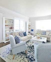 This open concept coastal living and dining space uses pops of blue to liven up the crisp, white walls. Blue And White Decor Ideas For Your Home Thistlewood Farm Blue And White Living Room Summer Living Room Farm House Living Room