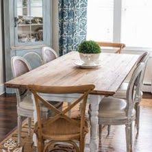 Layered rugs beneath the table help delineate the dining area, while pastel walls make the room feel more expansive and inviting. Va5qj Dg21dqnm