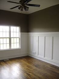 Wainscoting is, at it's most basic, a method of panelling a room. White Wainscoting With Wood Floors Hallway Family Room Dining Room Dining Room Wainscoting White Wainscoting Living Room Wood Floor